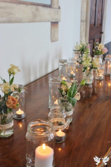 Jam jar flowers and tealights- Elizabeth Weddings